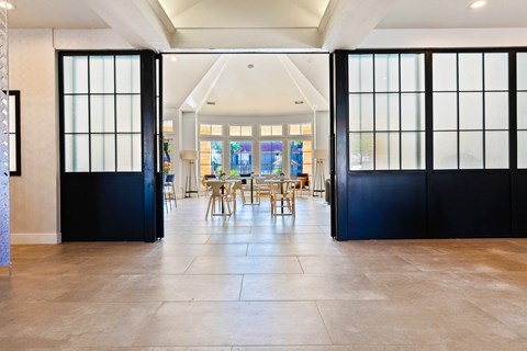 a dining room with black sliding doors and a table and chairs